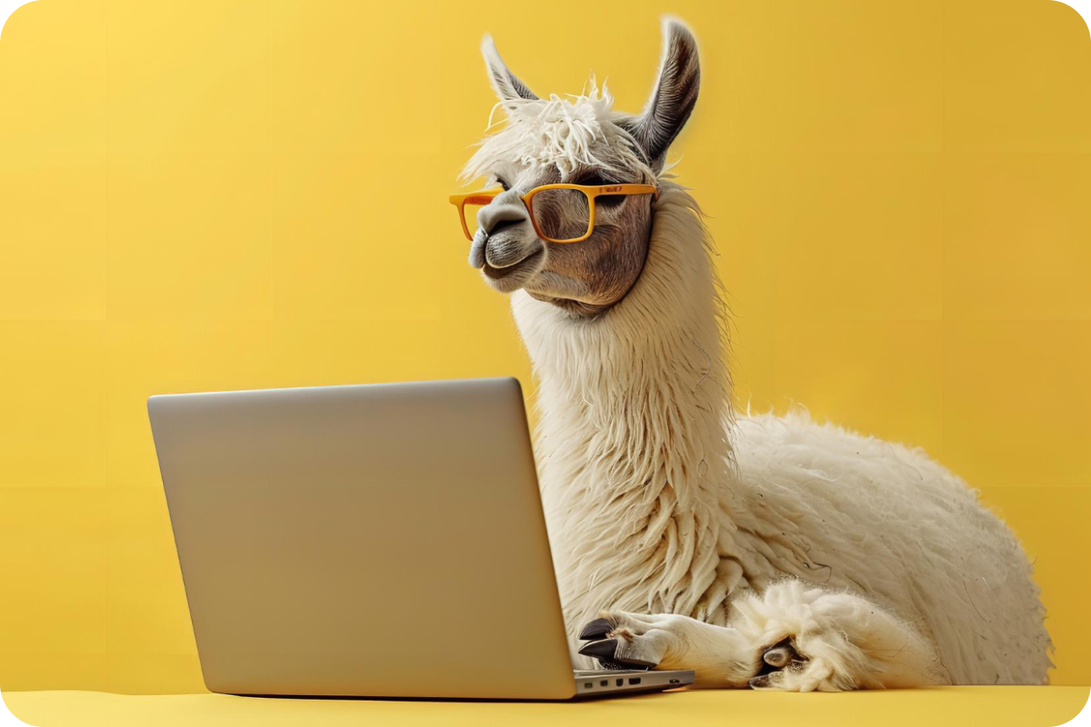 A llama with glasses sitting in front of a computer.