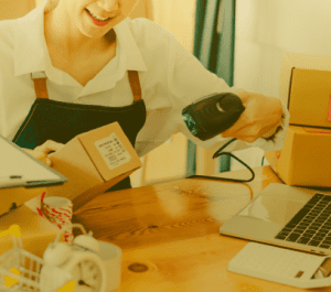 Saleswoman reading a barcode with a machine.