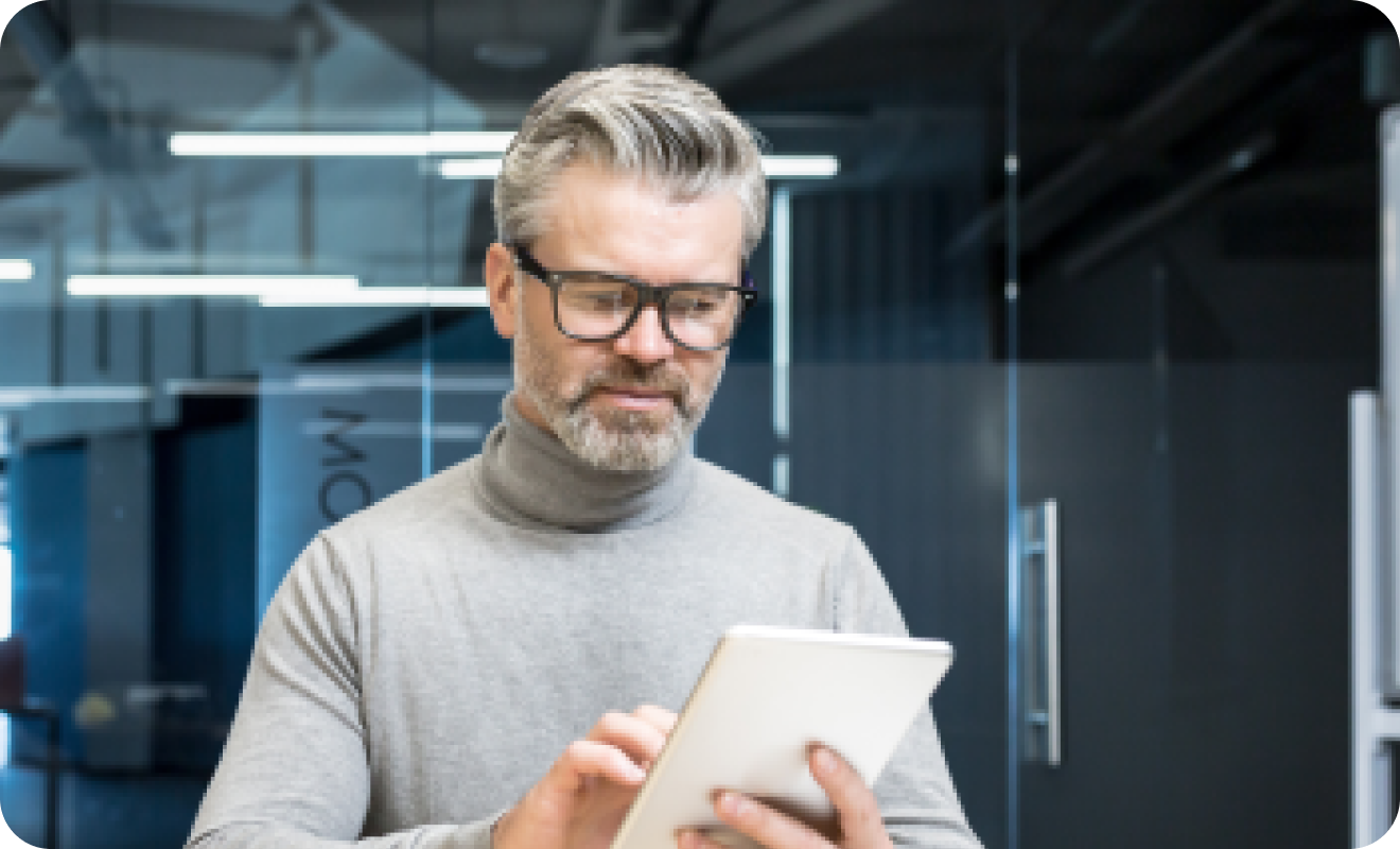 Man holding his tablet in his hands.